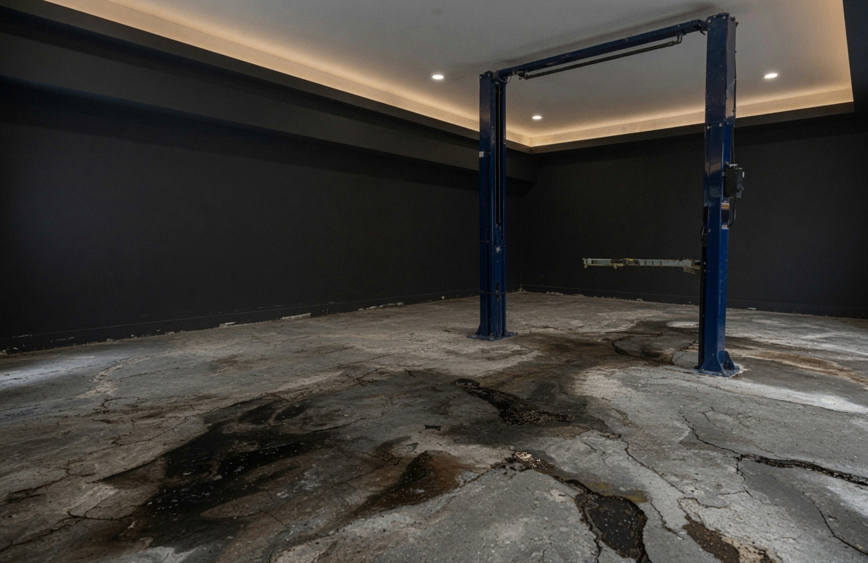 Before — bare cracked concrete garage floor